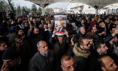Photo of man holding a poster