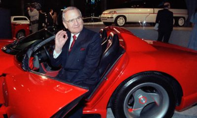 Photo of Lee Iacocca sitting in a 1990 Dodge Viper sports car in 1990
