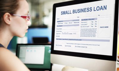 Photo of a woman looking at a small business loan form on a computer