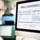Photo of a woman looking at a small business loan form on a computer